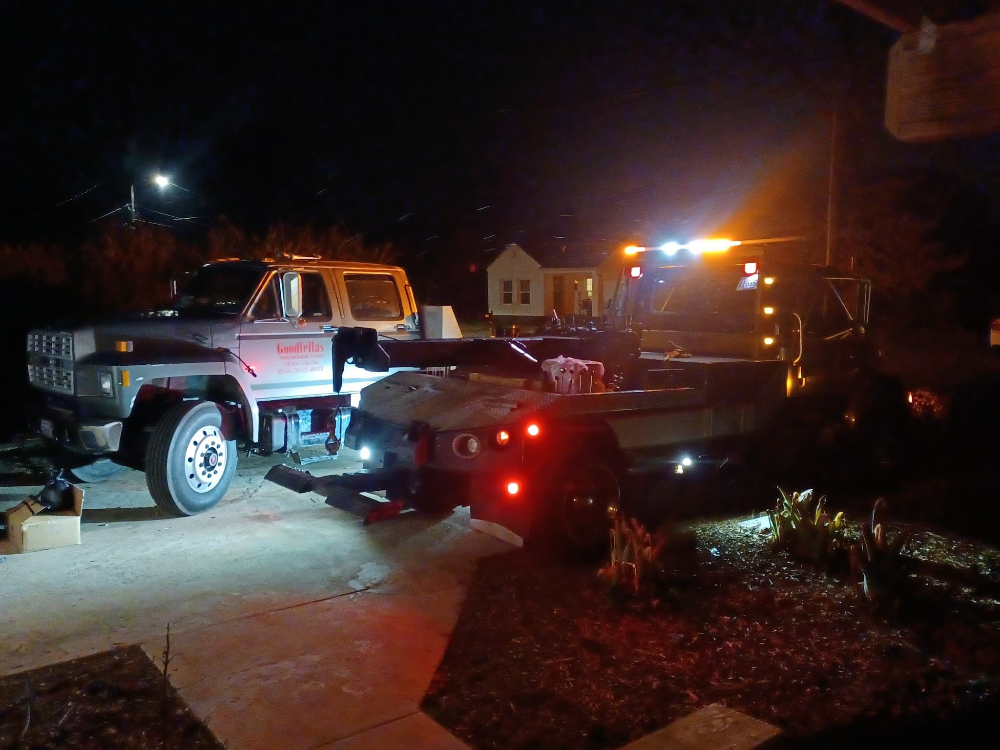 Goodfellas Towing branded flatbed on a late-night call in the Charlotte metro